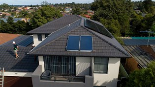 Solar hot water system solar collectors on roof of house